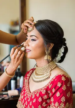 Bride having her makeup finished