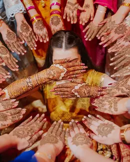 Bride surrounded by hennaed hands