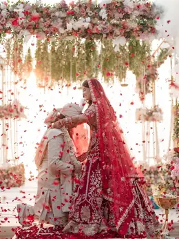 Bride placing the varmala on her groom